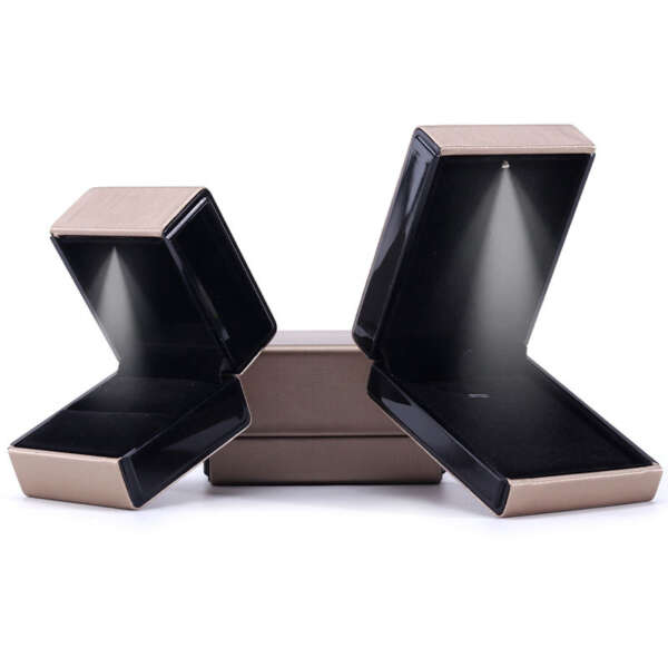 Open lighted jewelry box showing soft ring and necklace lining