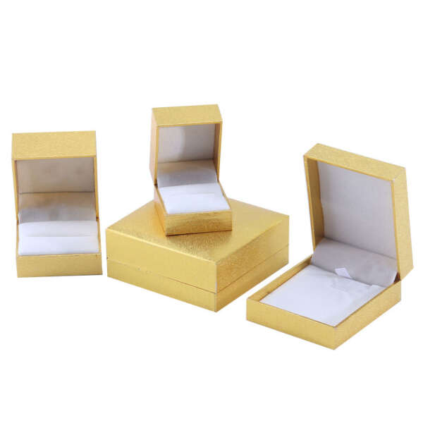 Open gold paper jewelry box showing soft interior